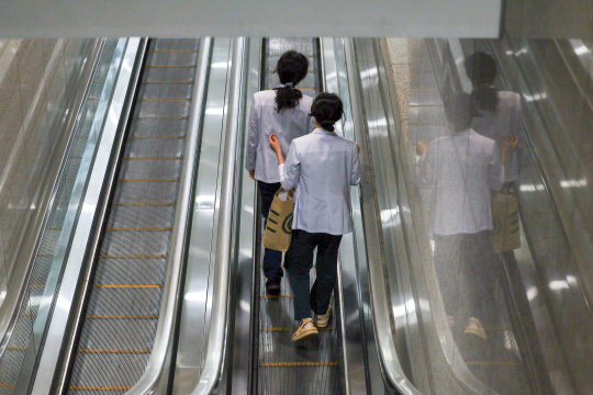 의대정원을 둘러싼 의정갈등이 이어지고 있는 가운데 21일 서울 한 대형병원에서 의료진이 이동하고 있다. 정부가 일부 국립대 총장들의 제안을 받아들여 2025학년도 의대 증원분을 각 대학이 50~100% 범위에서 자율적으로 정하도록 결정했지만 의료계는 근본적인 해결책이 아니라며 원점 재검토를 촉구하고 있다. [연합뉴스]